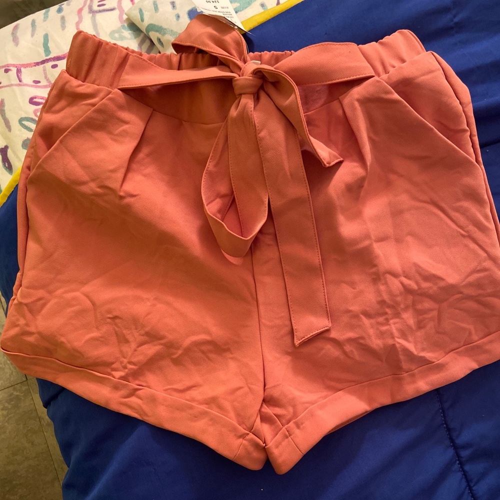 Pink high waisted shorts with a tie in the front